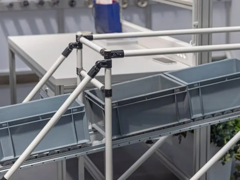Gravity conveyor with plastic bins on sloped frame designed for efficient warehouse material handling