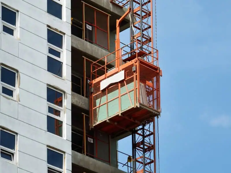 suspended hoist in construction lifting materials on high-rise building
